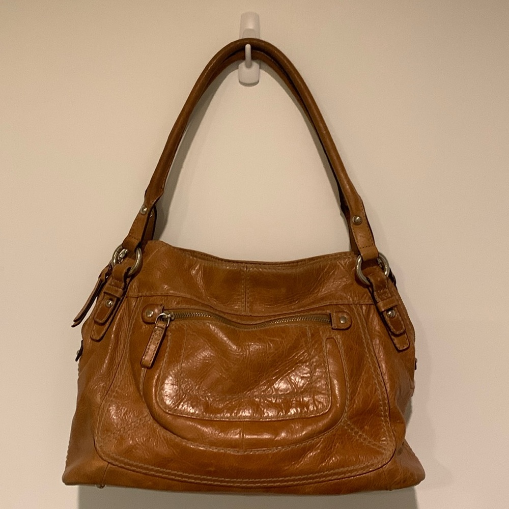 Danier light brown colored leather shoulder/handbag in GUC.